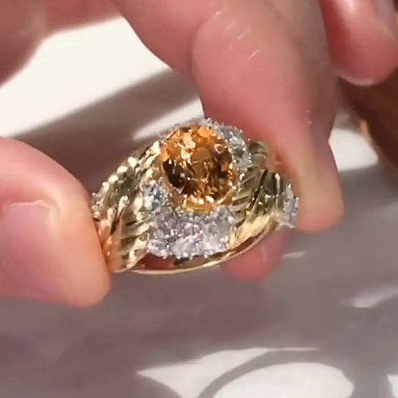 Gold colour copper ring with embossed feather design and inlaid yellow zircon stones.
