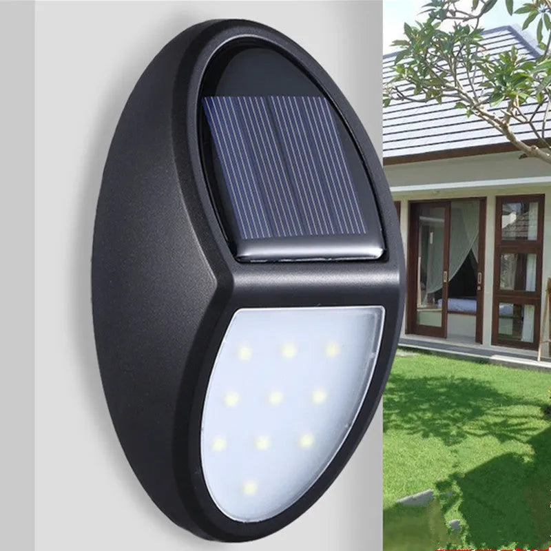 Black solar-powered LED wall light with solar panel and automatic activation