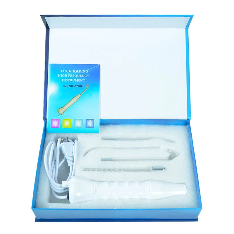 White hand held high frequency electrotherapy comb with glass tube accessories for acne and mite removal in box packaging