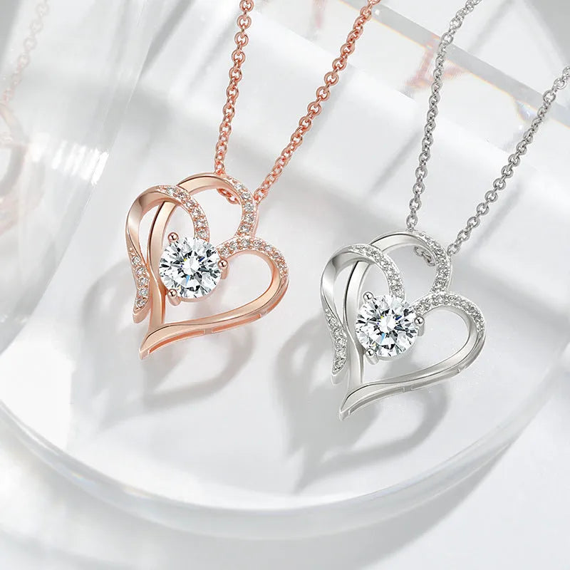 Close-up of a women's heart-shaped pendant necklace in 925 silver with a choice of gold tone finishes.