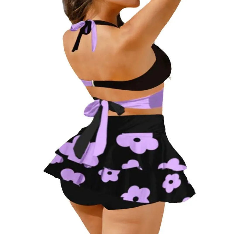 Women's purple bikini set with lace-up design featuring sleeveless top and high-waist split skirt