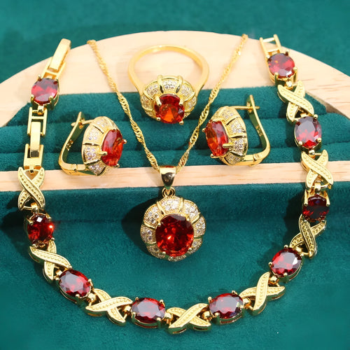 Gold coloured necklace, earrings, ring, and bracelet set with blue synthetic cubic zirconia stones.