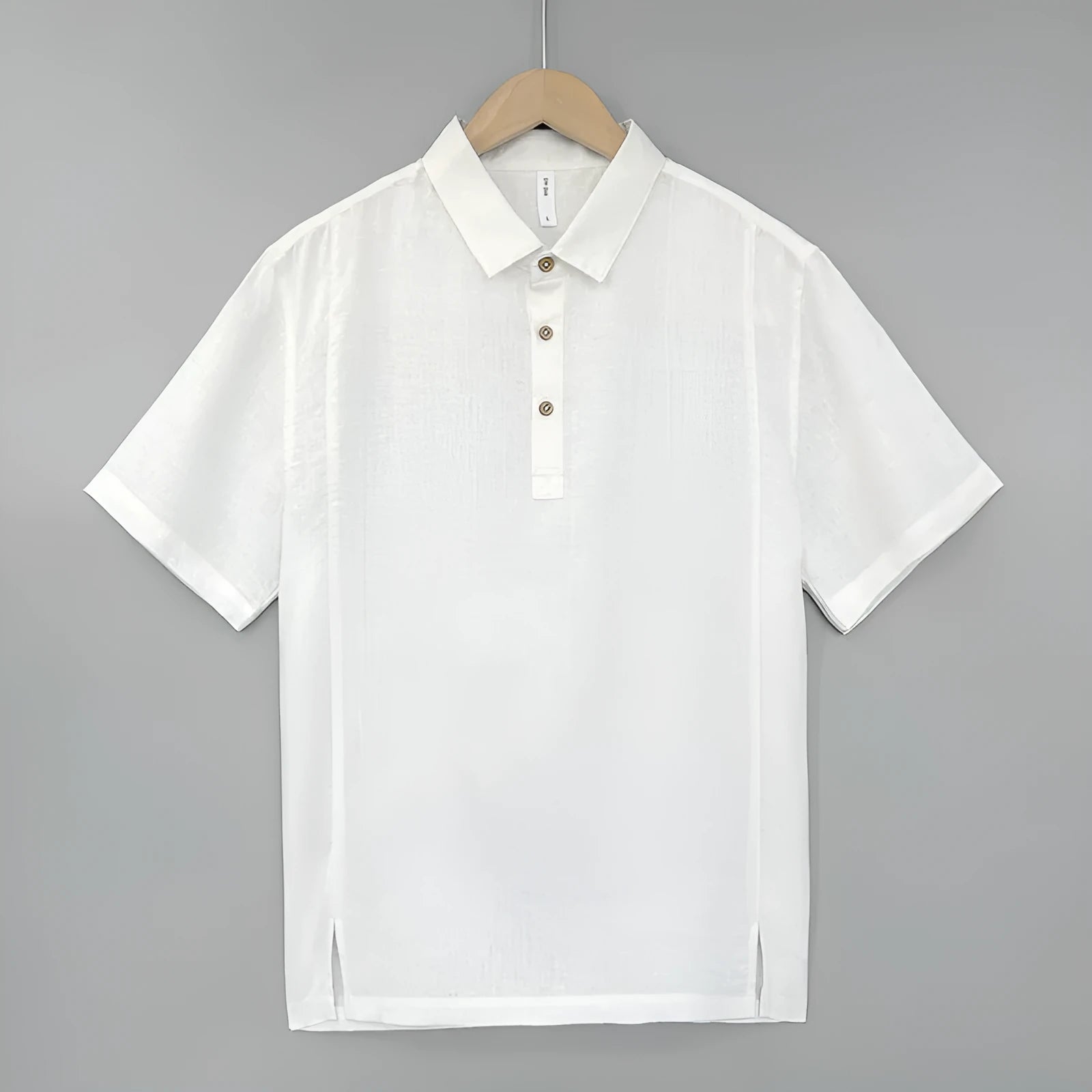 Men's loose grey green linen summer top with thin lapel collar and short sleeves laid flat.