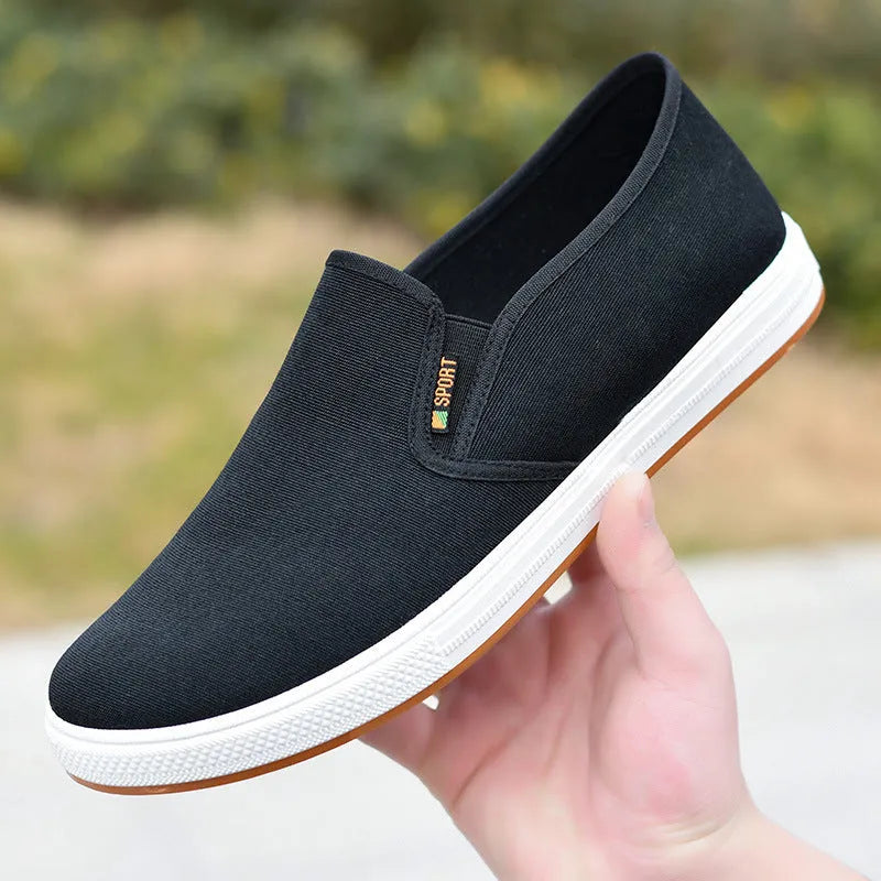 Men's black canvas slip-on shoes with round toe and low-top design