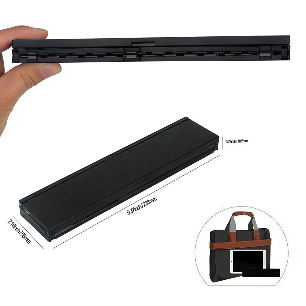 Black folding Bluetooth wireless keyboard next to tablet showing compact portable design