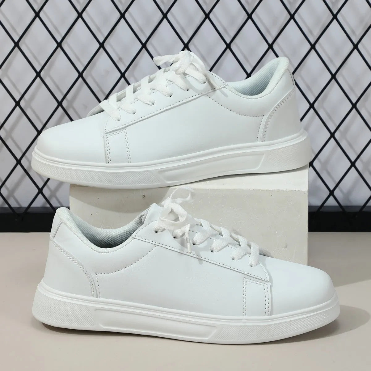 Beige brown platform skateboard sneaker with low top, round toe, and cross-belt design on a white background.
