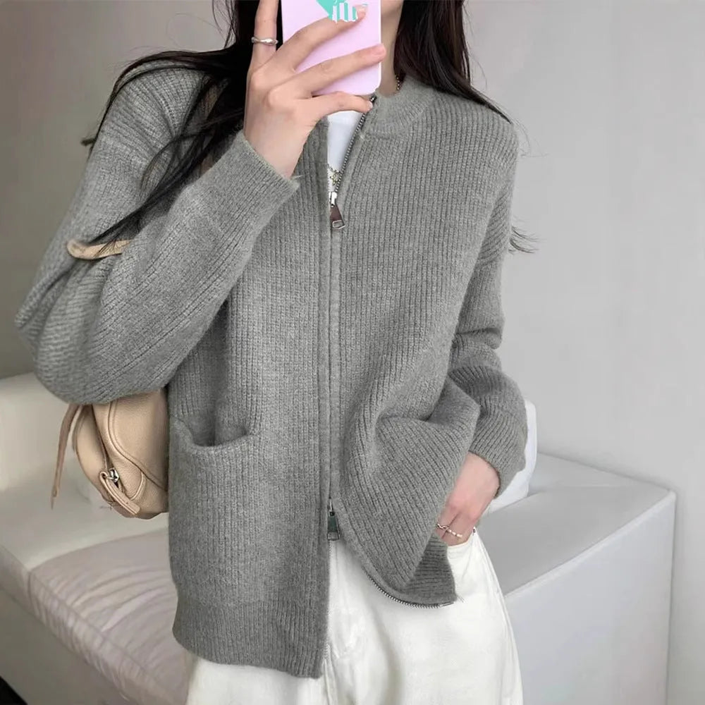 Beige viscose knit cardigan coat with long sleeves on a hanger.