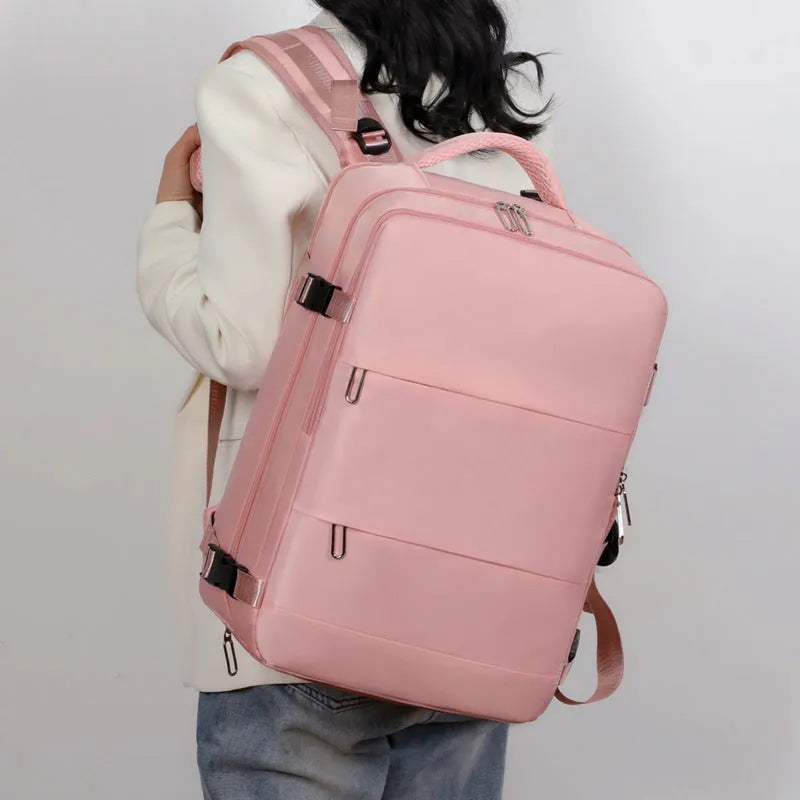 Large purple travel backpack with multiple compartments, shown with a laptop and organised interior.