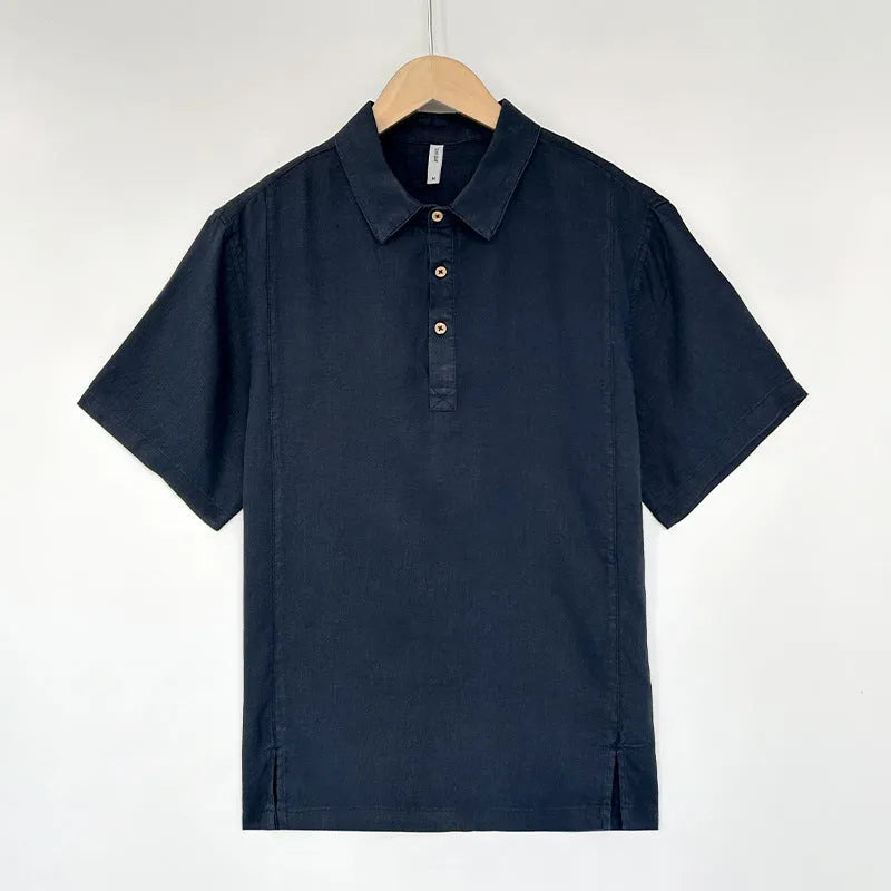 Men's loose grey green linen summer top with thin lapel collar and short sleeves laid flat.