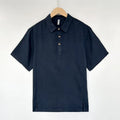 Men's loose grey green linen summer top with thin lapel collar and short sleeves laid flat.