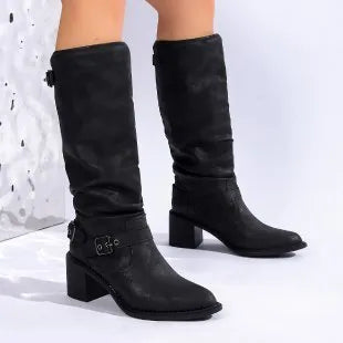 Women's black chunky heel boots with pointed toe and high shaft on display