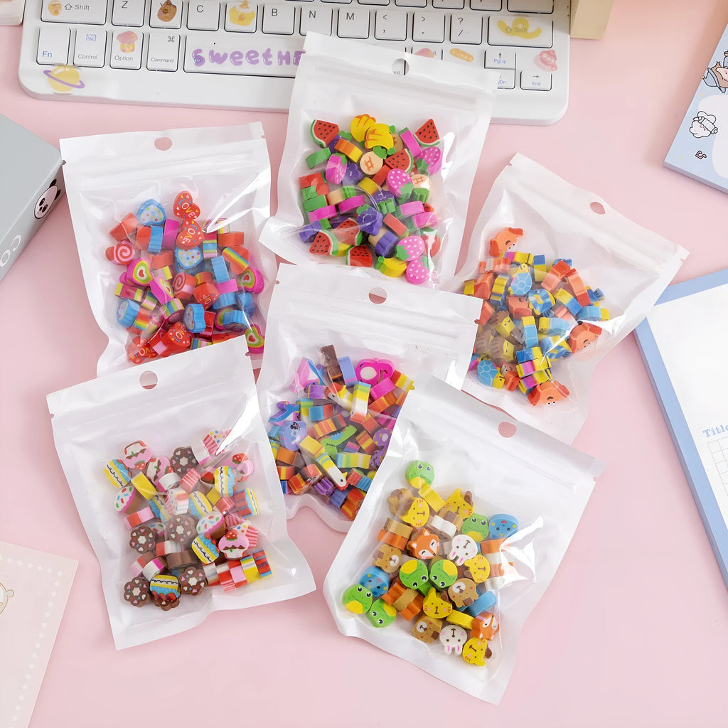 50 small colourful cartoon erasers in a pearlescent bag showing fruit, animal, cake, and Halloween themes.