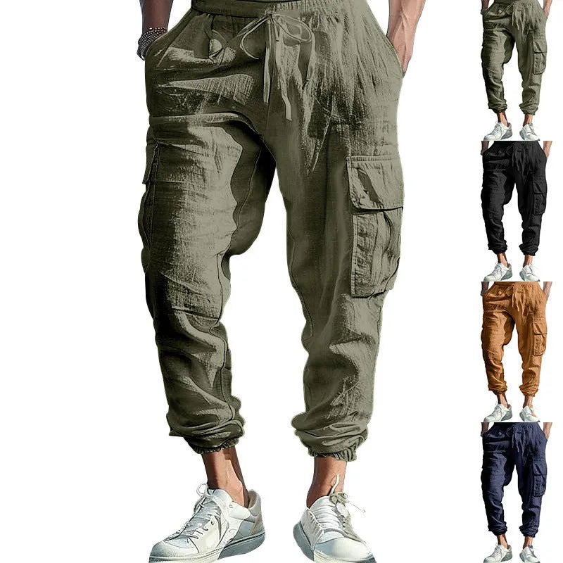 Man wearing loose, ankle-tied linen trousers in a solid colour with visible pockets.