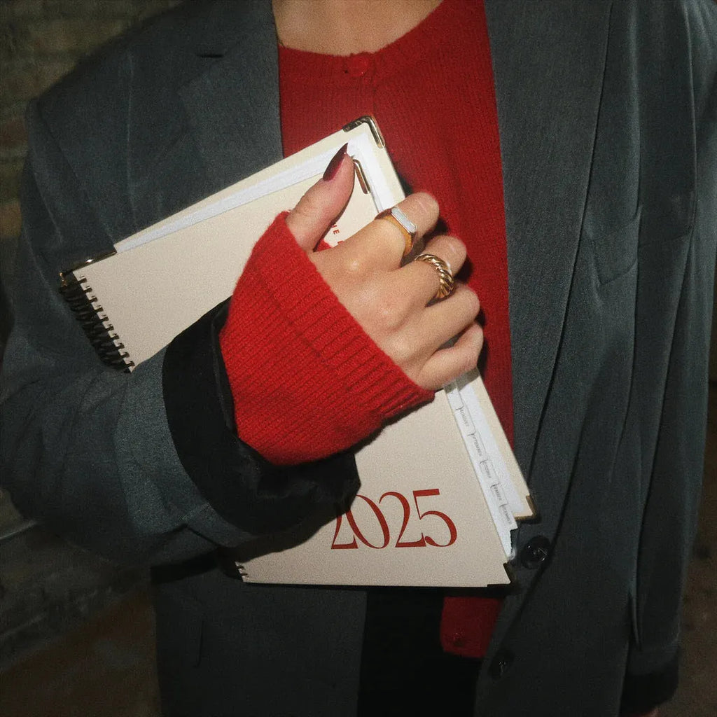 Cherry red coil notebook with spiral binding open to show paper pages