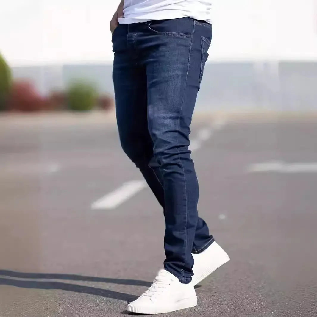 Men's dark blue slim-fit skinny casual jeans on a neutral background