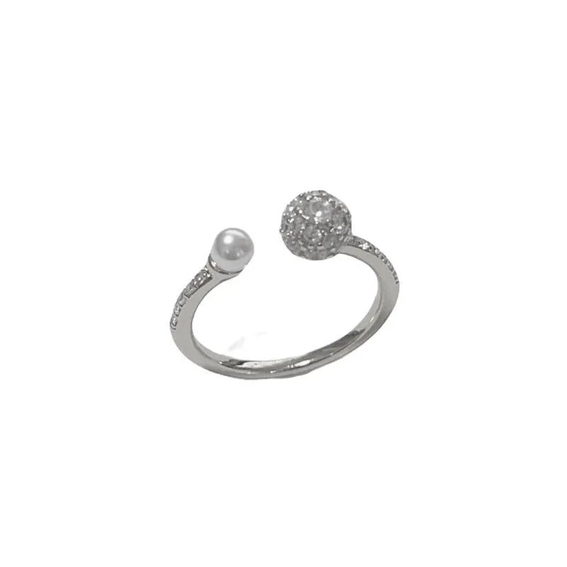 Open-end pearl ring with round zircon stone in gold or silver finish on geometric copper band