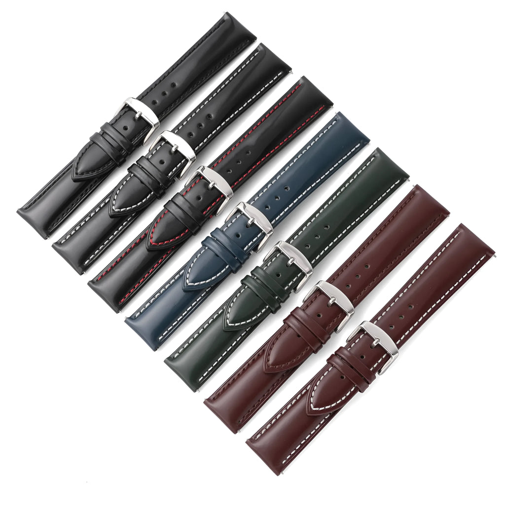 Quick release cowhide leather watch strap in black and white line colour on a watch.