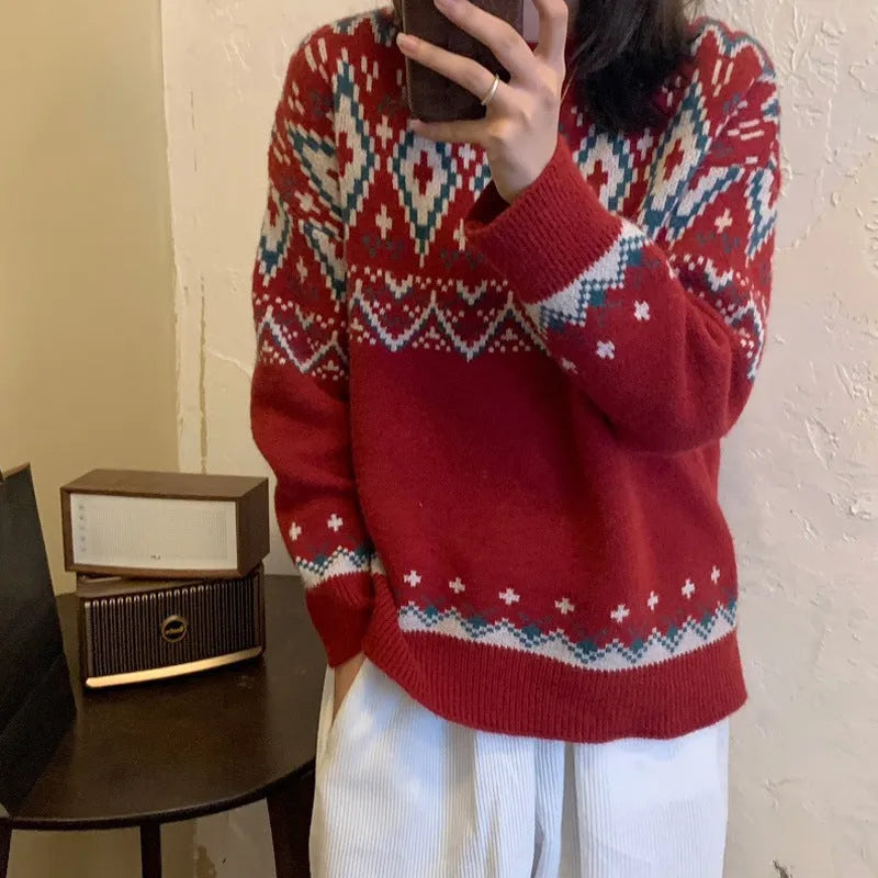 Red and white striped loose fit pullover knitted top with long sleeves on a mannequin.