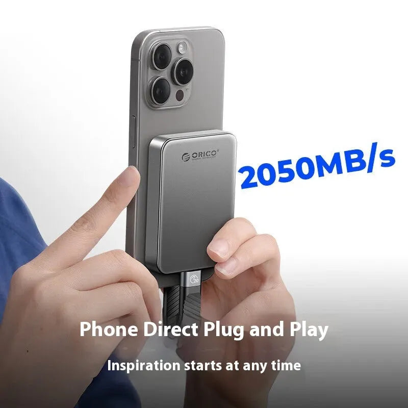Grey magnetic mobile solid state drive with USB-C cable and magnetic suction ring.