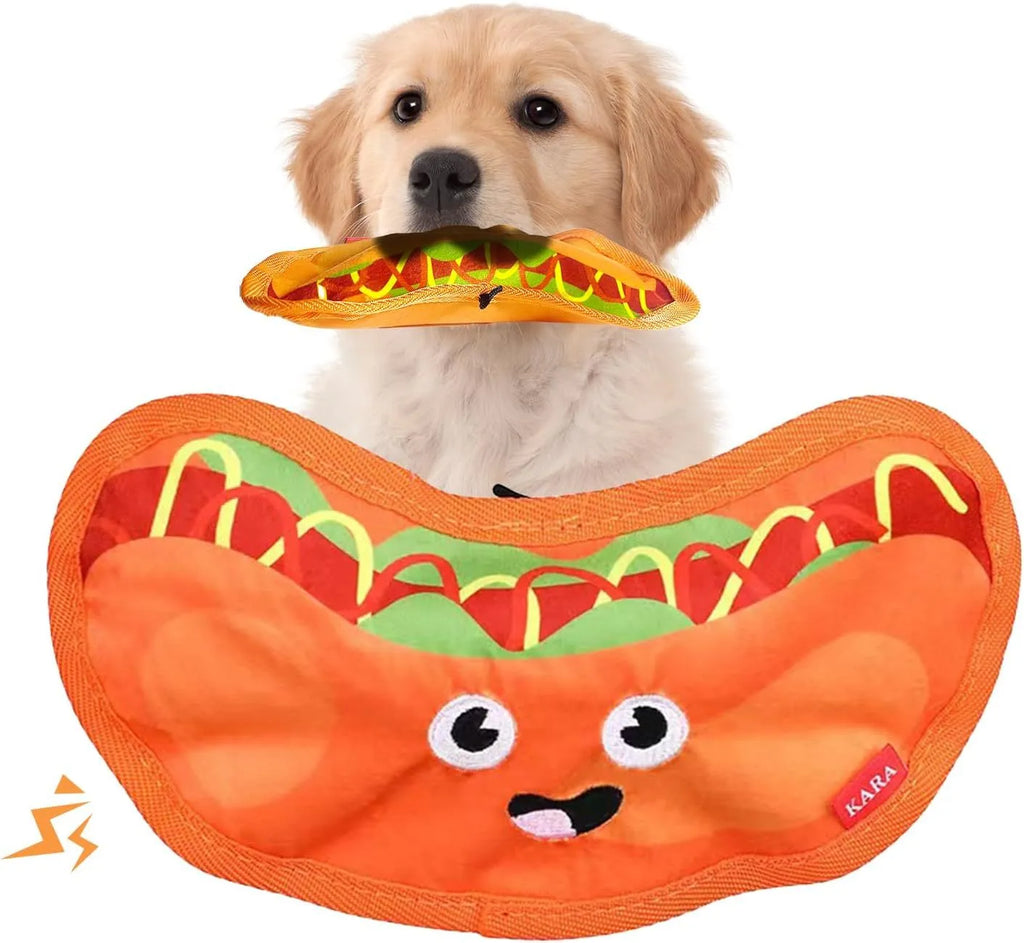 Colourful crinkle and squeaky dog chew toys shaped like a hamburger, fries, a hot dog, and a pizza on a plain background.