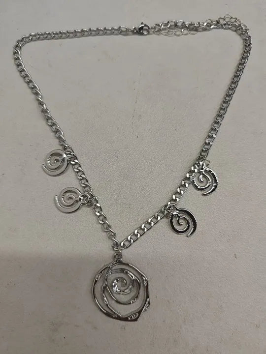 Women's spiral donut jewellery set showing matching necklace, bracelet and ear hooks in gold or silver electroplated alloy