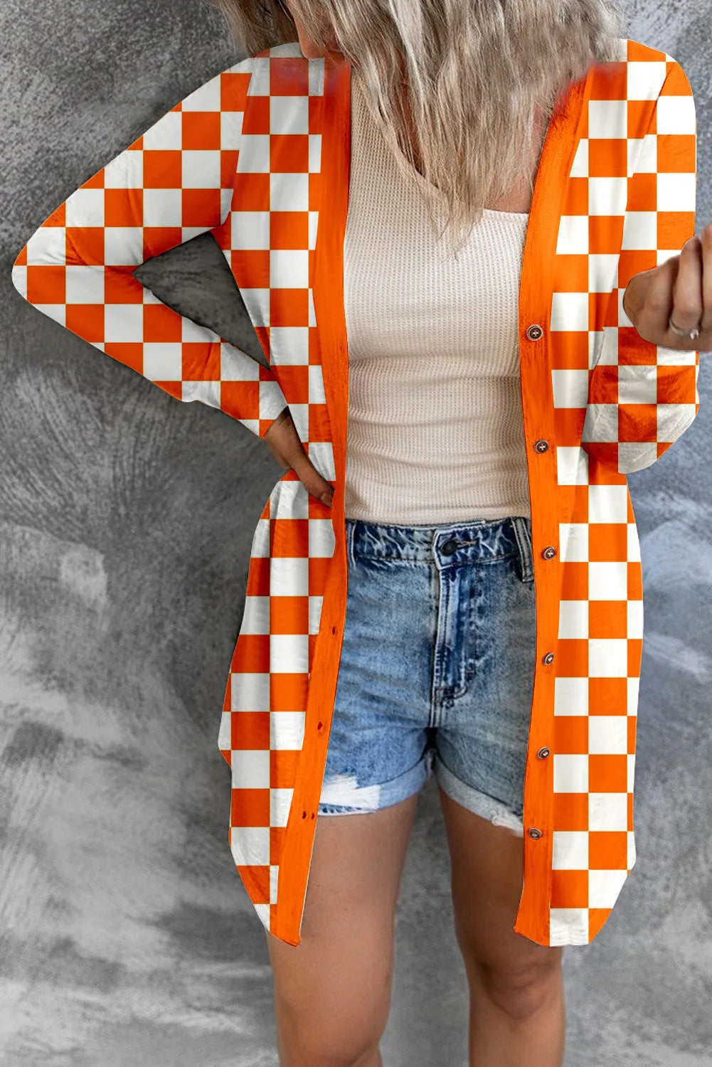Long grey plaid knitted cardigan coat on a model, showing loose fit and regular sleeves.