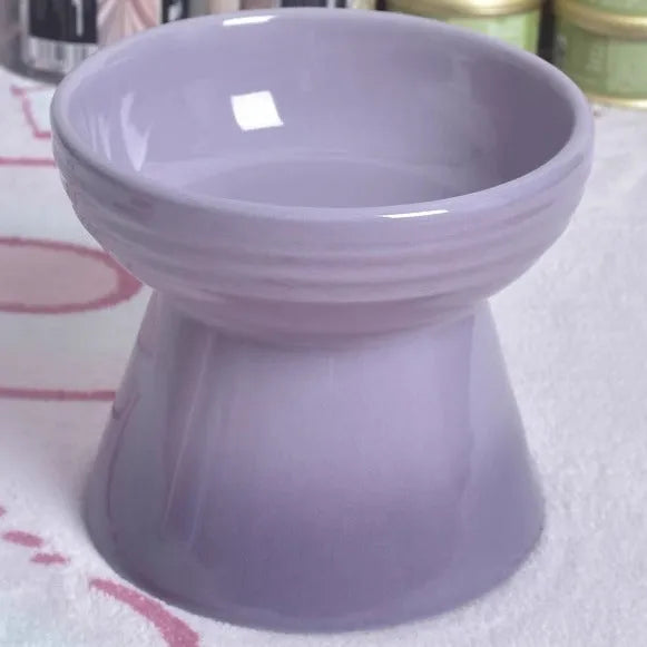 Black ceramic pet bowl with a raised foot and high neck guard for dogs and cats.