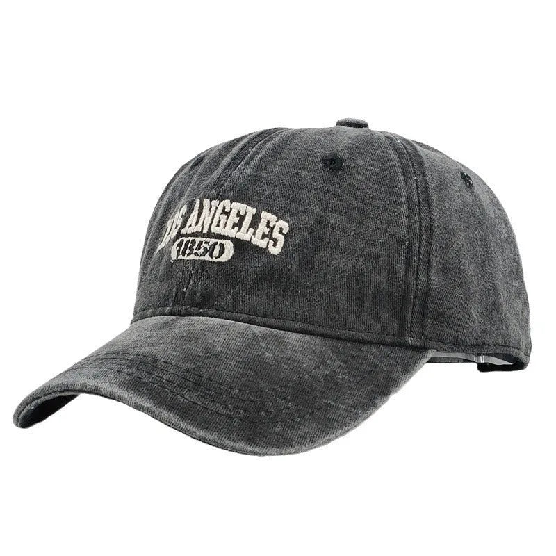 Retro peaked cap with distressed letter embroidery and adjustable sizing in conical crown design