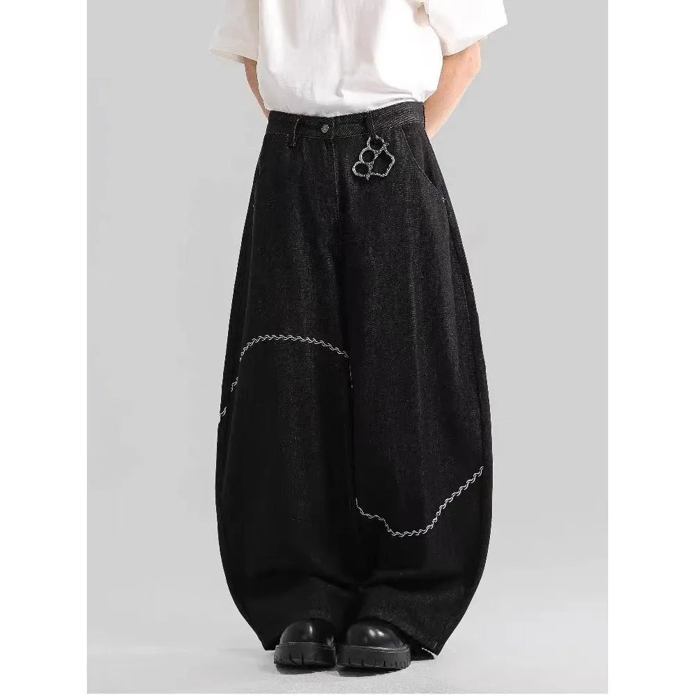 Black straight-leg denim trousers on a hanger, showing mid waist and zip placket detail.