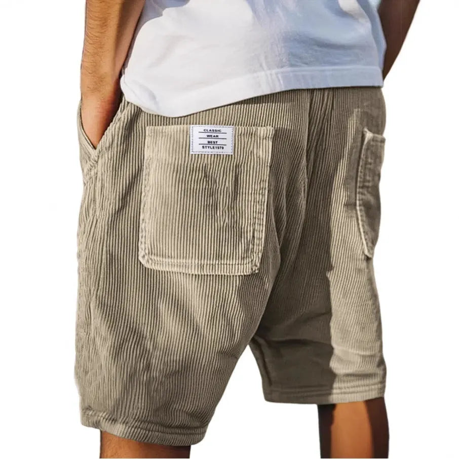 Men's grey corduroy shorts with multiple pockets and embroidery detail on leg, laid flat.