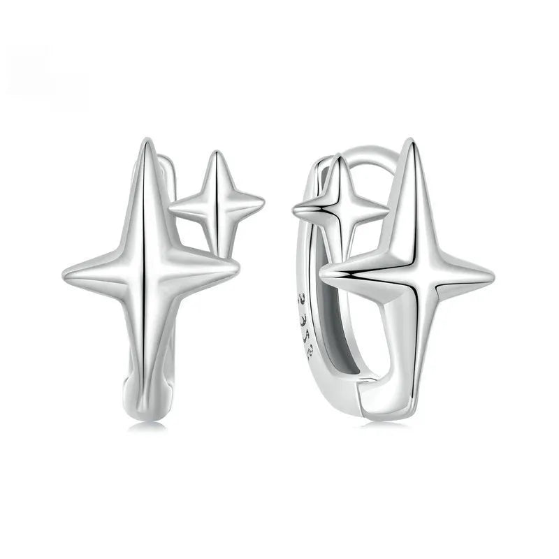 Minimalist oxidised sterling silver star clip-on earrings with XINGX detail on a white background.