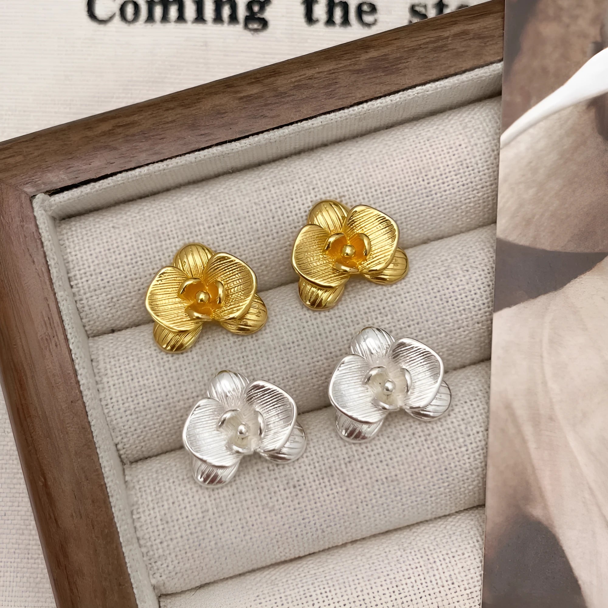 A pair of retro-style copper flower earrings with petal details in a gold electroplated finish.