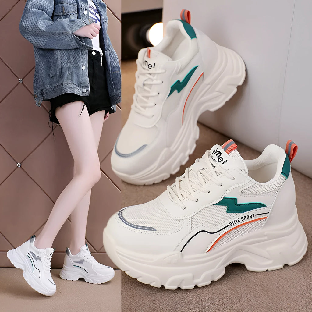 White women's low-top dad shoes with cross straps and lace-up front, showing round toe and rubber sole.