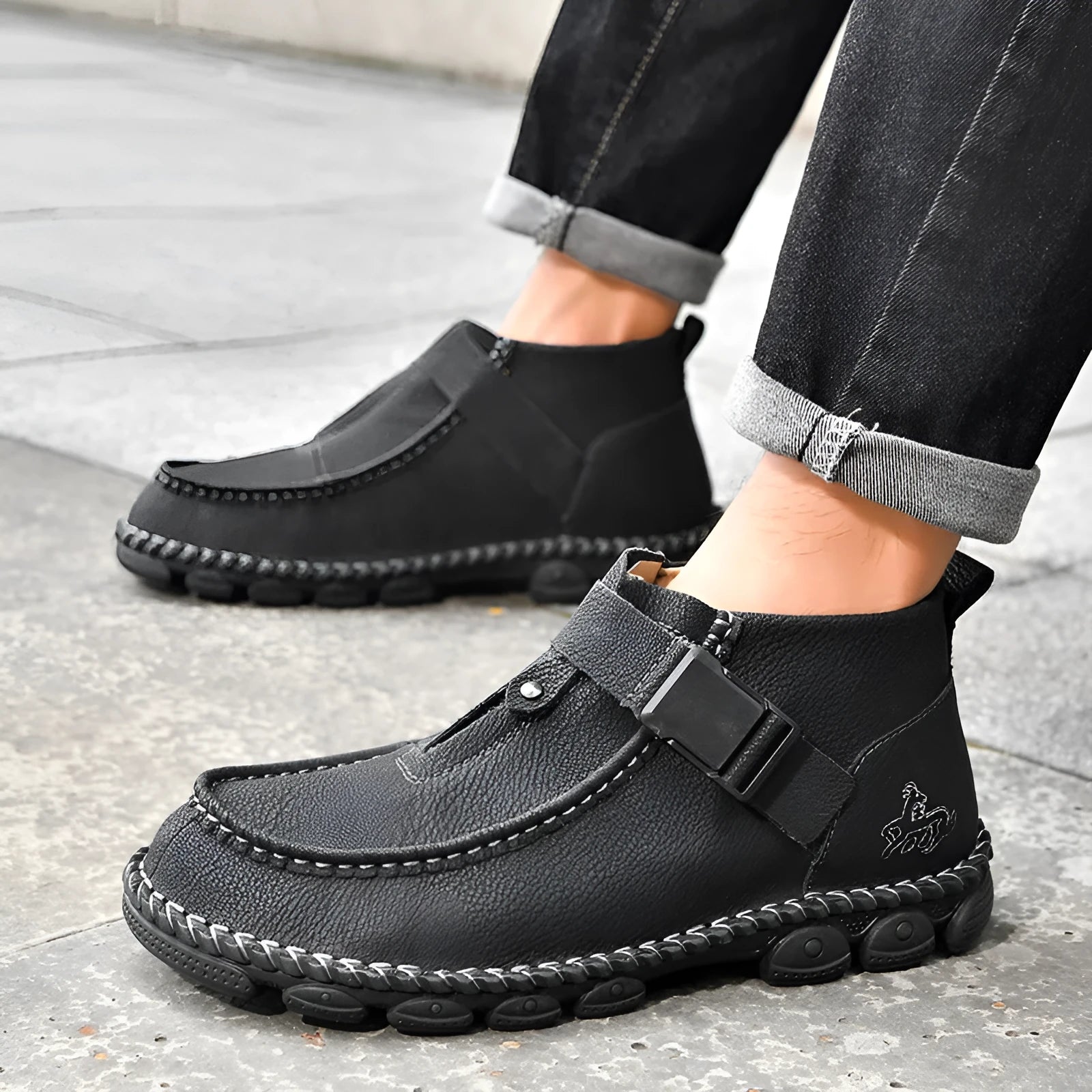 Black synthetic leather slip-on flat shoes with handmade stitching on the sole