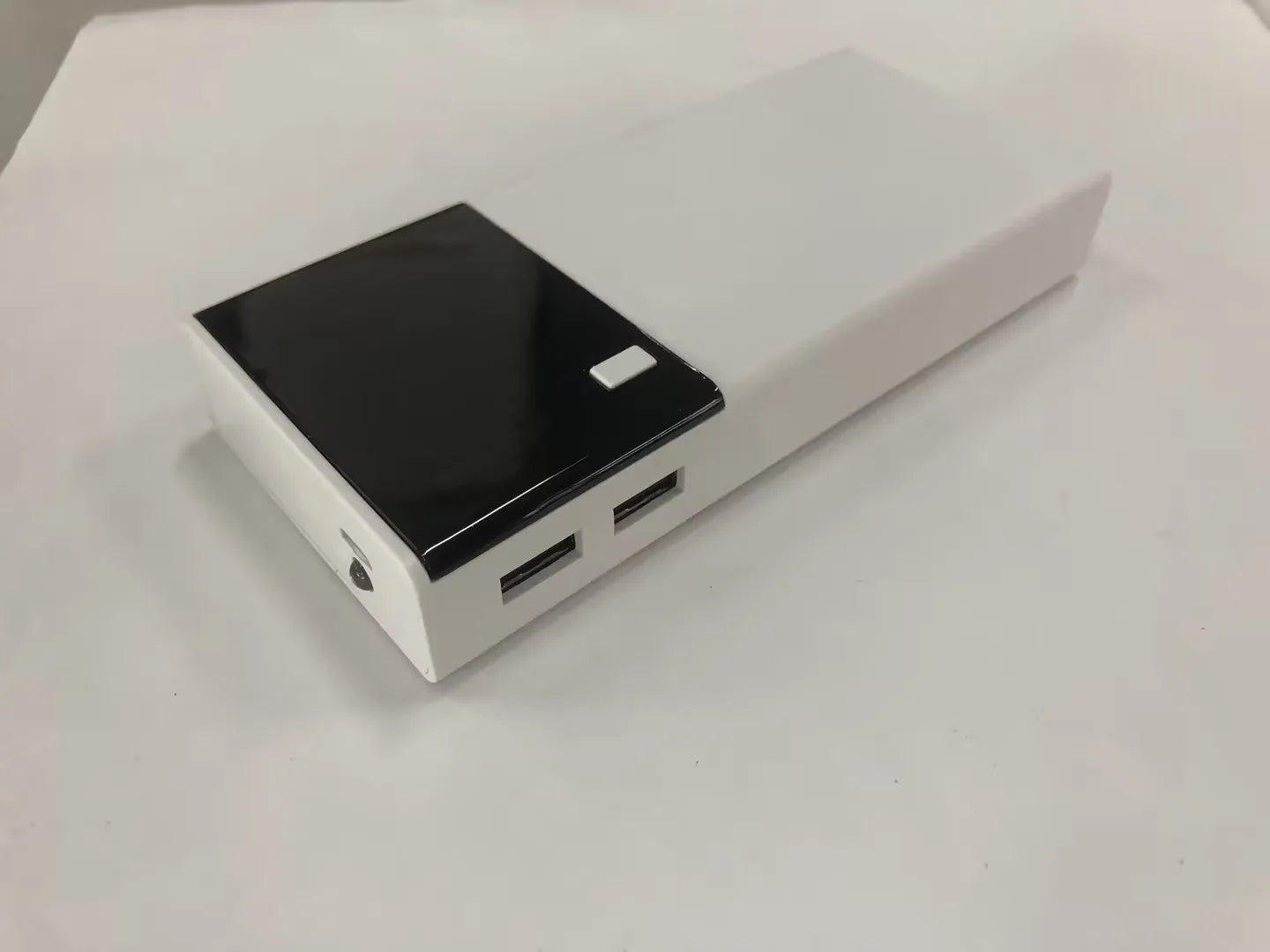 Black 20000mAh power bank with charging cable, dimensions 135mm by 60mm by 20mm