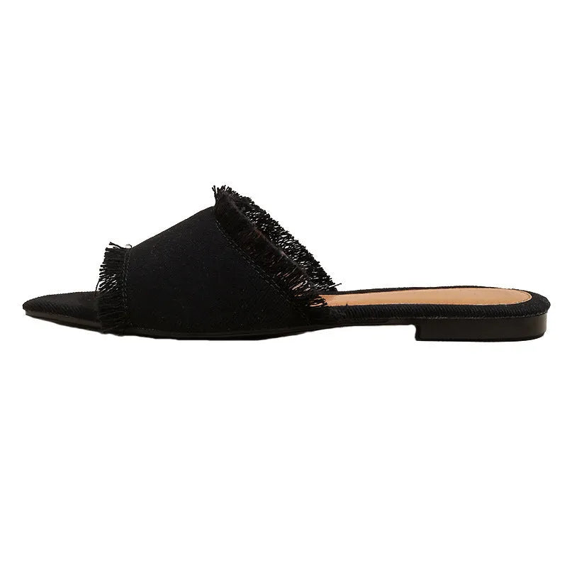 Women's flat denim slippers with tassel detail in apricot colour on a white background