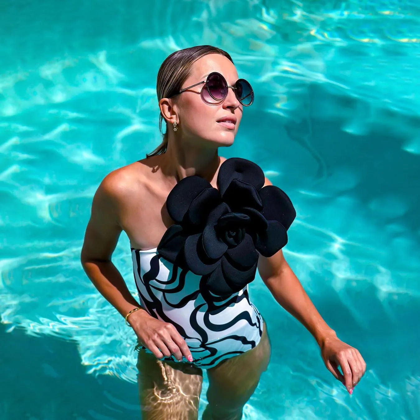 One-piece floral swimsuit on a hanger with optional matching skirt, showing European and American fit.