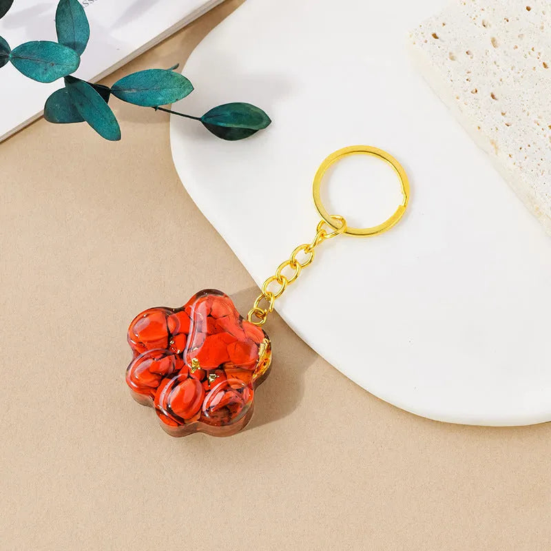 Natural crystal cat's paw keychain pendant in various gemstone colours including pink, red, blue, and green