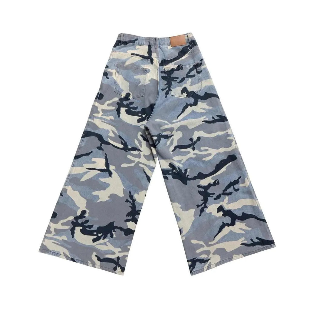 Man and woman modelling loose-fit jeans in a blue snow camouflage pattern with stretch denim fabric.