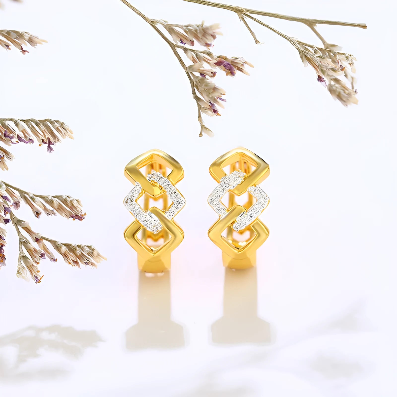 Geometric hollow-out gold-colour alloy earrings with an ear clip fastening.