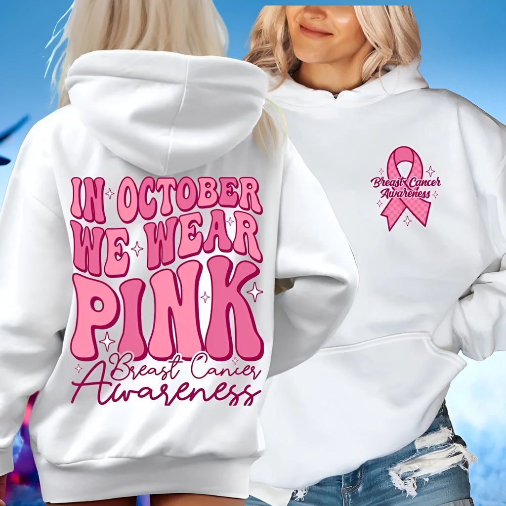 Pink pullover hoodie with a breast cancer awareness slogan, retro graphic, and side seam pockets.