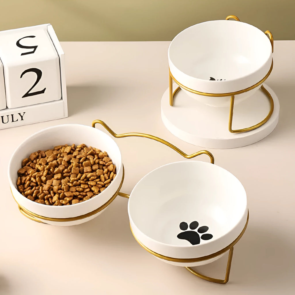 White ceramic cat bowl with cat paw print pattern in a black iron cat-ear frame