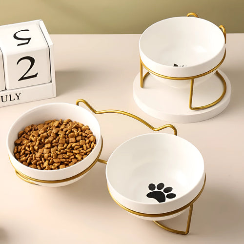 White ceramic cat bowl with cat paw print pattern in a black iron cat-ear frame