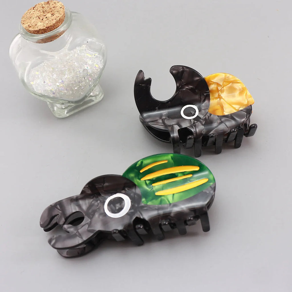 Handmade cellulose acetate hair clip with cartoon beetle design in green or orange colour options