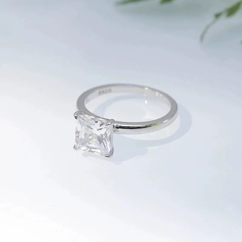 Simple geometric 925 silver ring in silver, gold, and rose gold colours on a plain background.