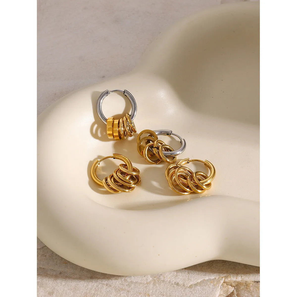 A pair of stainless steel electroplated earrings with a colour matching finish in a simple ins style.