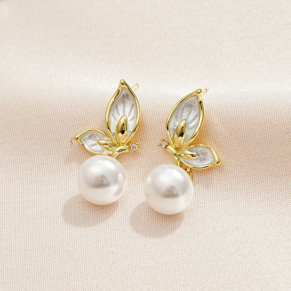 Gold-tone butterfly earrings with zircon painting detail on copper wings