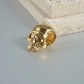 Stainless steel geometric earrings with hollow skull and Buddha head design in electroplated colour options.