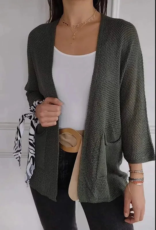 Women's thin waffle weave cardigan coat in army green with pockets, shown on a hanger.
