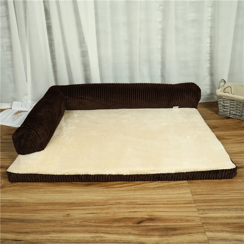 A corduroy pet sofa dog bed with a raised bolster, shown in a grey colour on a wooden floor.